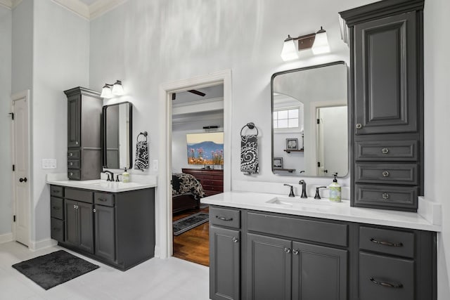 full bath featuring a high ceiling, two vanities, a sink, and connected bathroom