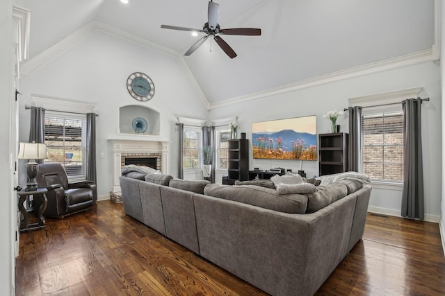 living room featuring a brick fireplace, plenty of natural light, high vaulted ceiling, and dark wood-style flooring