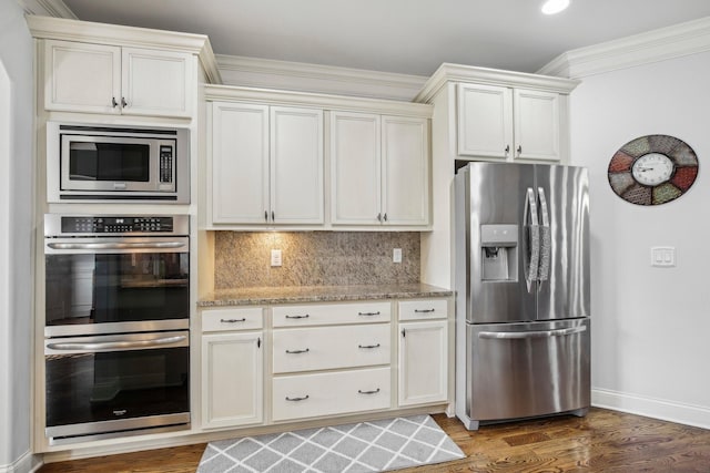 kitchen with light stone counters, decorative backsplash, appliances with stainless steel finishes, ornamental molding, and wood finished floors