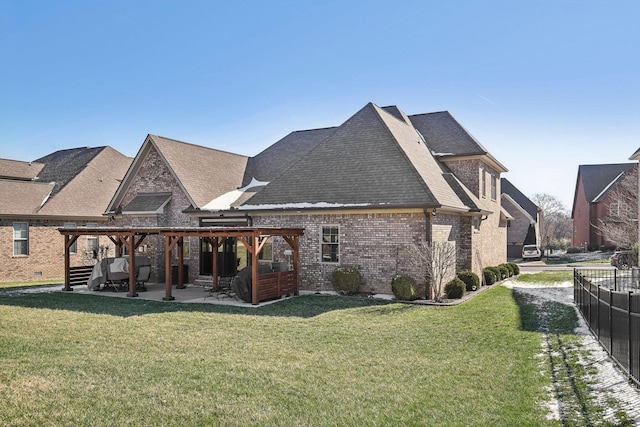 back of property featuring a yard, a patio, brick siding, and a pergola