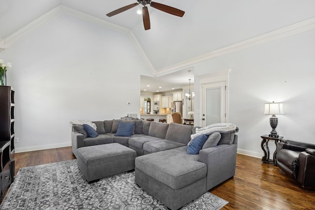 living room with baseboards, dark wood finished floors, ornamental molding, high vaulted ceiling, and ceiling fan with notable chandelier