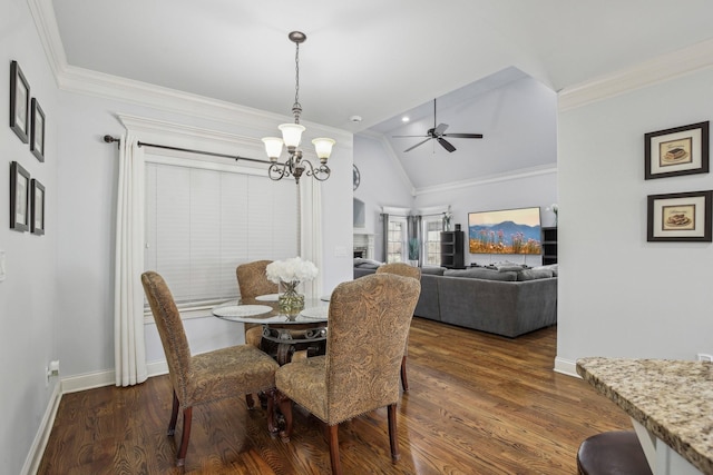 dining space featuring lofted ceiling, baseboards, ornamental molding, and dark wood-style flooring