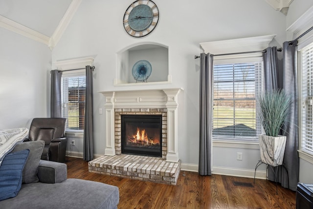 sitting room featuring crown molding, a fireplace, visible vents, vaulted ceiling, and wood finished floors