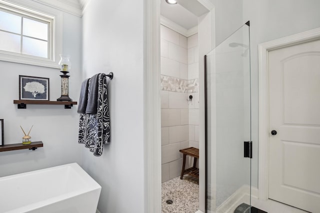 bathroom with a stall shower and a freestanding tub