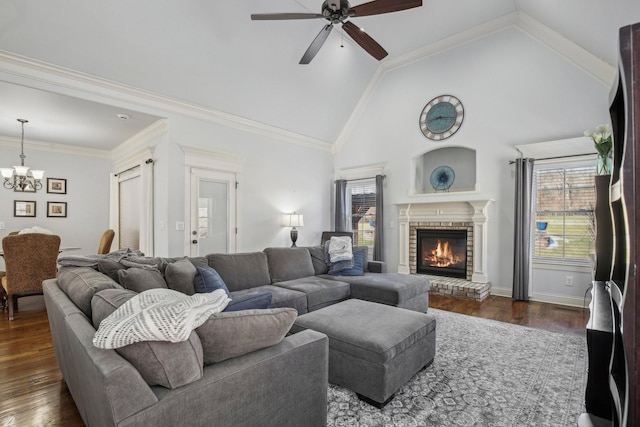 living area featuring high vaulted ceiling, a healthy amount of sunlight, dark wood finished floors, and a fireplace