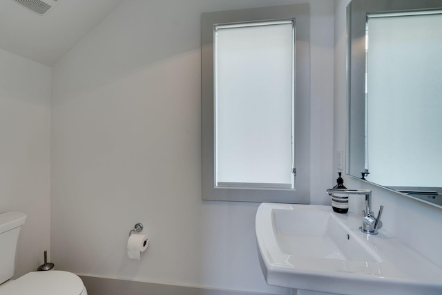 bathroom with visible vents, a sink, and toilet