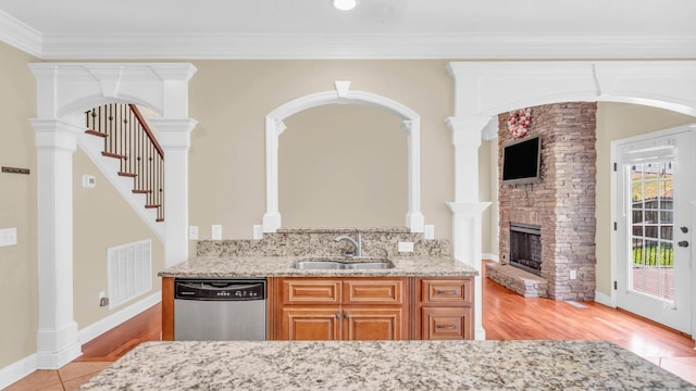 1108 City View Ter, Chattanooga, TN 37421 - kitchen with dishwasher, light stone countertops, a stone fireplace, light wood-style flooring, and crown molding
