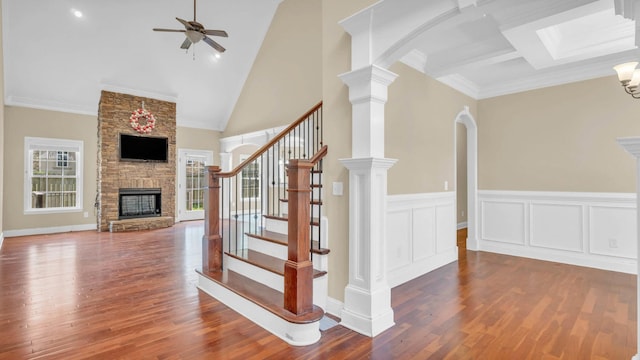1108 City View Ter, Chattanooga, TN 37421 - staircase featuring a stone fireplace, a ceiling fan, wood finished floors, ornamental molding, and high vaulted ceiling