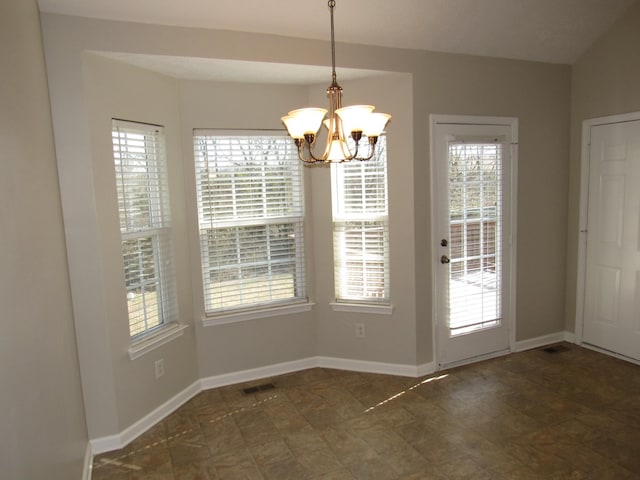 unfurnished dining area with a notable chandelier, a wealth of natural light, visible vents, and baseboards