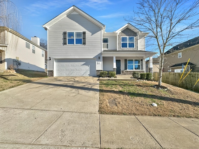 view of front of house with a porch, an attached garage, fence, concrete driveway, and stone siding