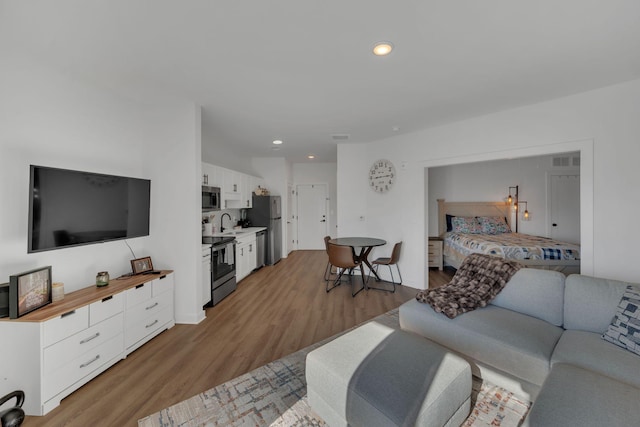 living area featuring recessed lighting and wood finished floors