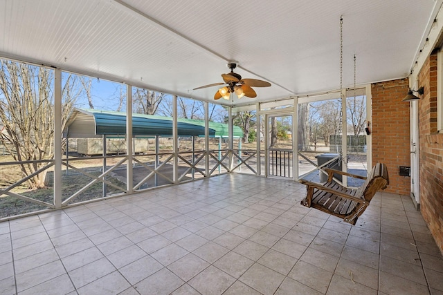 unfurnished sunroom with ceiling fan