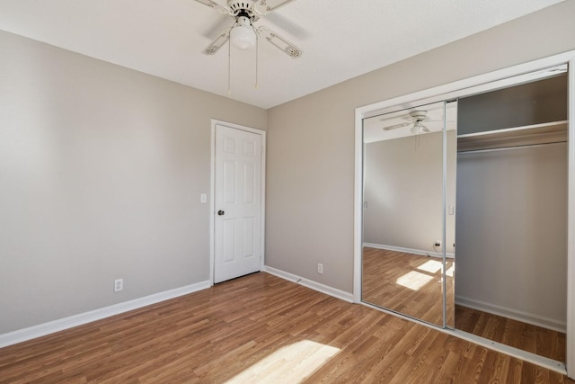 unfurnished bedroom with light wood finished floors, ceiling fan, baseboards, and a closet