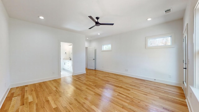 unfurnished bedroom with light wood finished floors, baseboards, visible vents, connected bathroom, and recessed lighting