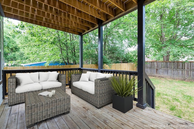 wooden deck with a fenced backyard and an outdoor living space