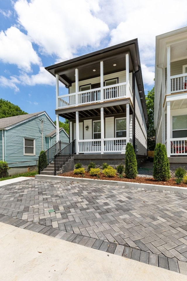 view of front of home with a porch and a balcony