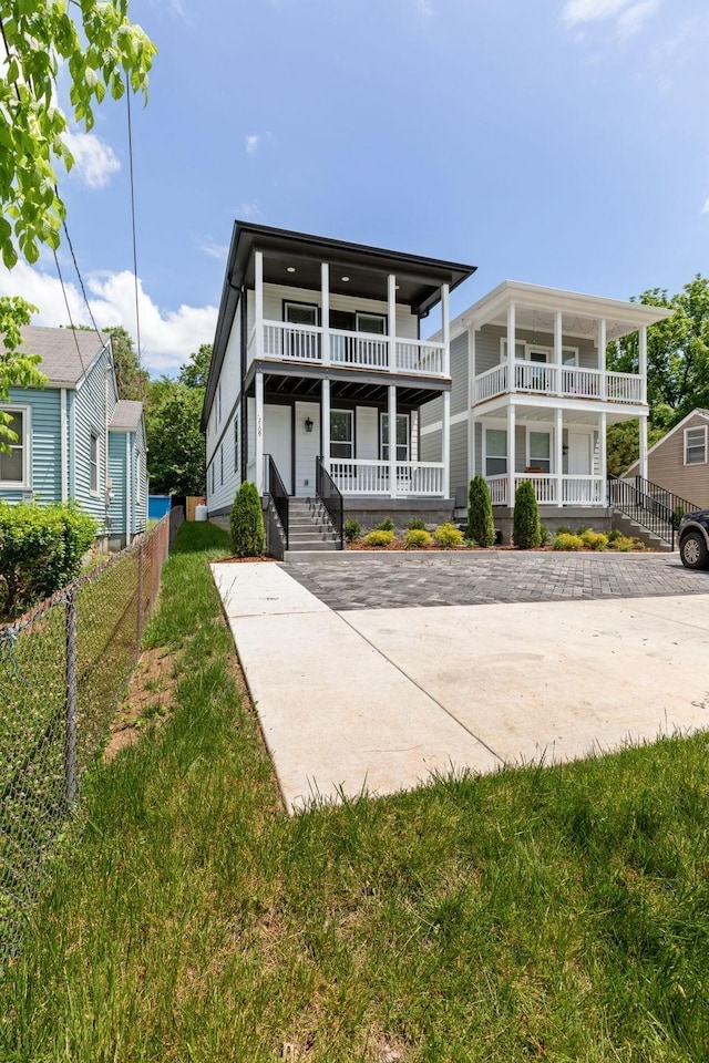 view of front of home featuring covered porch and a front yard