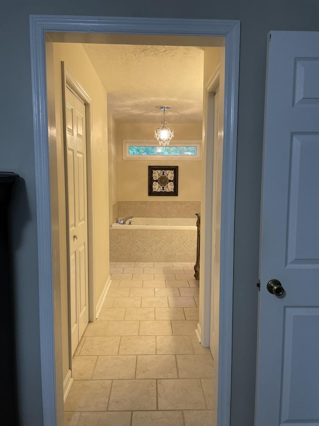 hall featuring an inviting chandelier