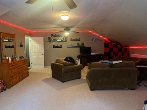 interior space featuring ceiling fan, vaulted ceiling, and carpet flooring