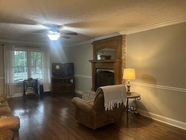 living area featuring a brick fireplace, a textured ceiling, crown molding, and wood finished floors