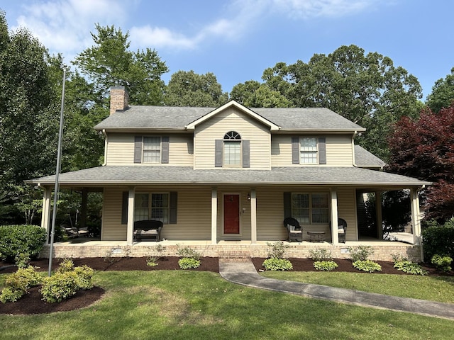 farmhouse-style home with a front yard, covered porch, roof with shingles, and a chimney