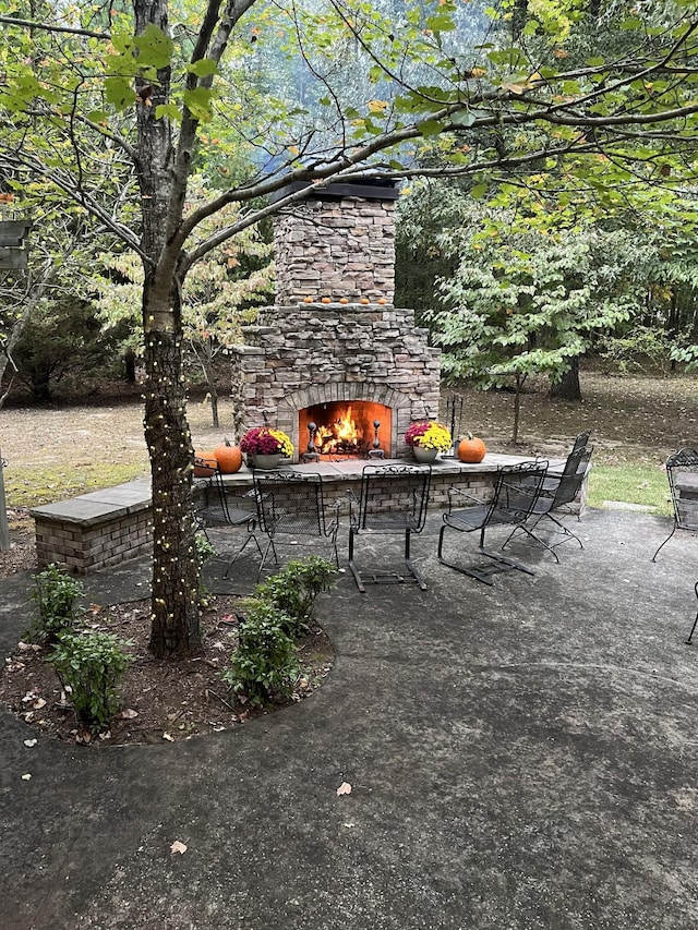 view of patio with an outdoor stone fireplace