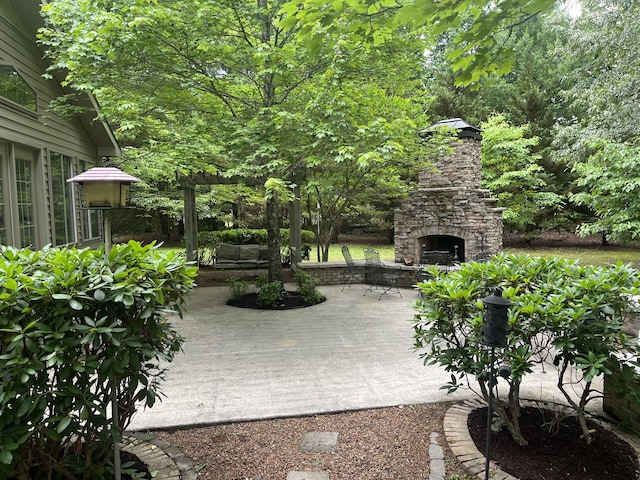 view of patio with an outdoor stone fireplace