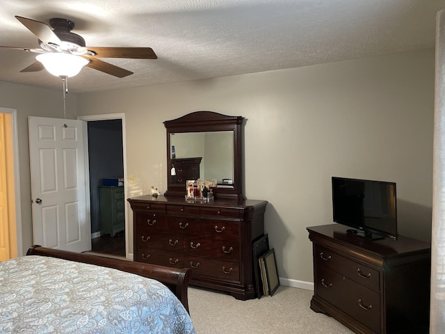 bedroom featuring ceiling fan, baseboards, and a textured ceiling