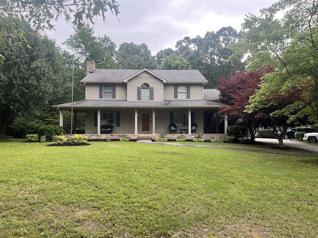 country-style home featuring a front yard, covered porch, and a chimney