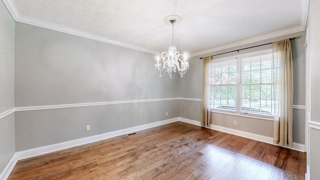 830 Motlow College Rd, Normandy, TN 37360 - spare room featuring wood finished floors, ornamental molding, and a chandelier
