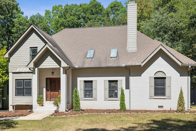 view of front of house with brick siding, roof with shingles, a chimney, crawl space, and a front lawn