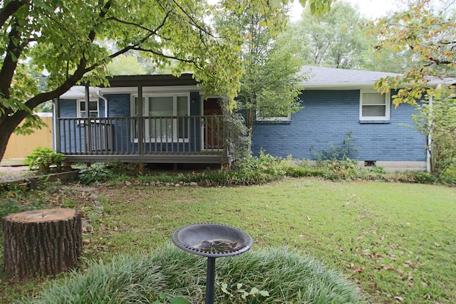 view of front of home with a front yard and brick siding