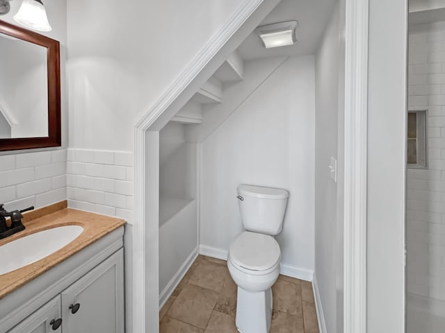 bathroom with tile patterned floors, vanity, toilet, and baseboards