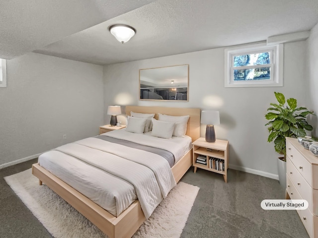 bedroom with a textured ceiling, carpet floors, and baseboards