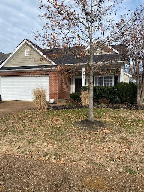 view of front of house with brick siding and an attached garage