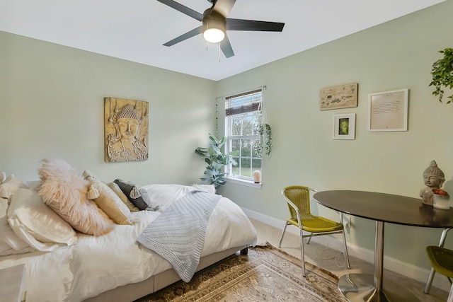 bedroom featuring ceiling fan and baseboards