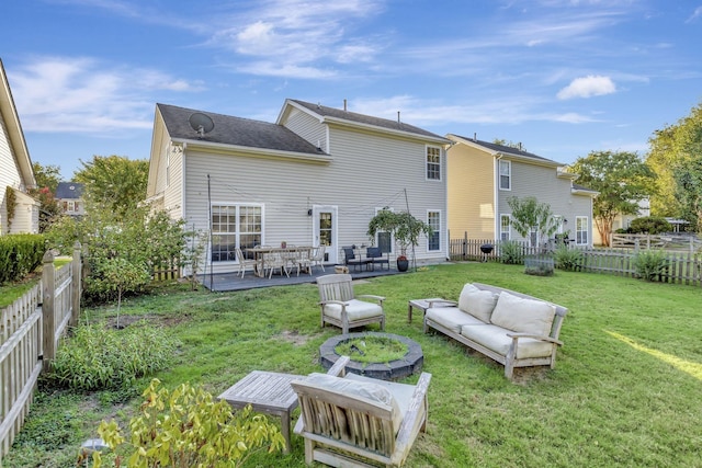 back of house with a patio area, outdoor lounge area, a lawn, and a fenced backyard