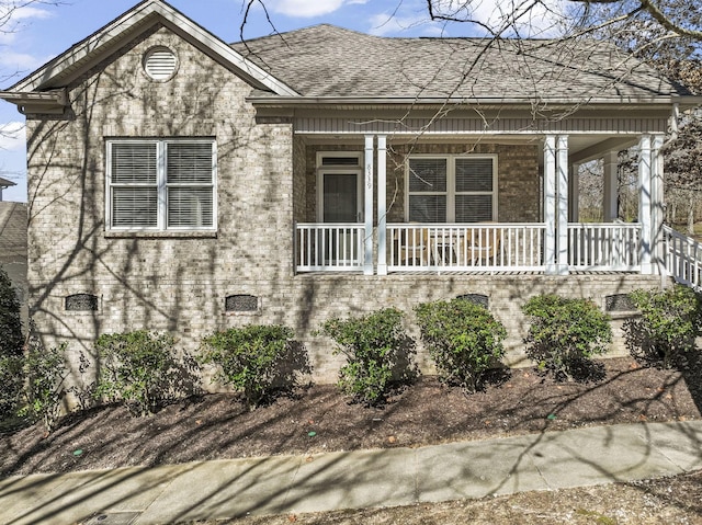 view of front of house with a porch and a shingled roof