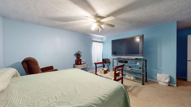 bedroom featuring a ceiling fan, light carpet, a textured ceiling, and baseboards