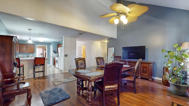 dining space featuring visible vents, baseboards, ceiling fan, and wood finished floors