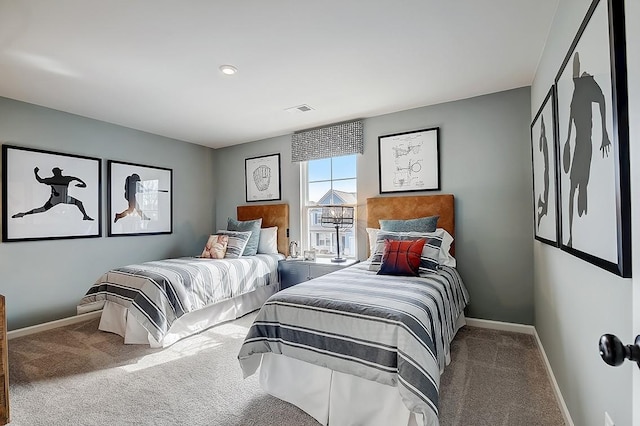 carpeted bedroom with visible vents and baseboards