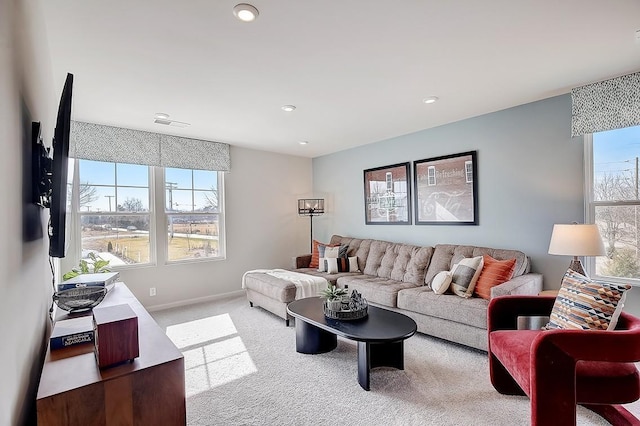 carpeted living room featuring plenty of natural light and baseboards