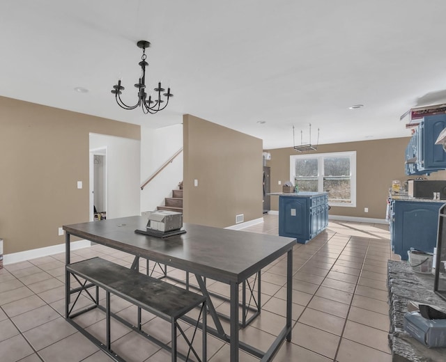 dining area with stairs, baseboards, a notable chandelier, and light tile patterned flooring