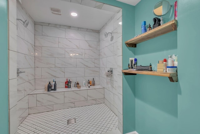 bathroom with tiled shower