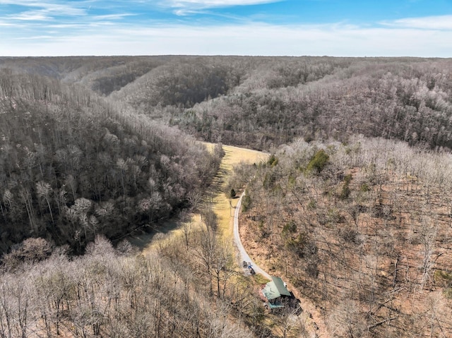 drone / aerial view featuring a view of trees