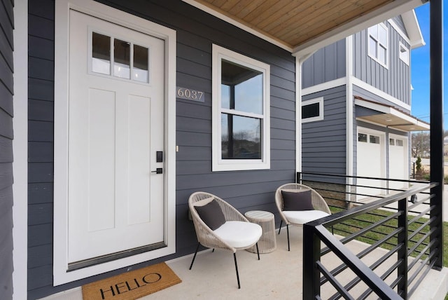 entrance to property with board and batten siding and a balcony