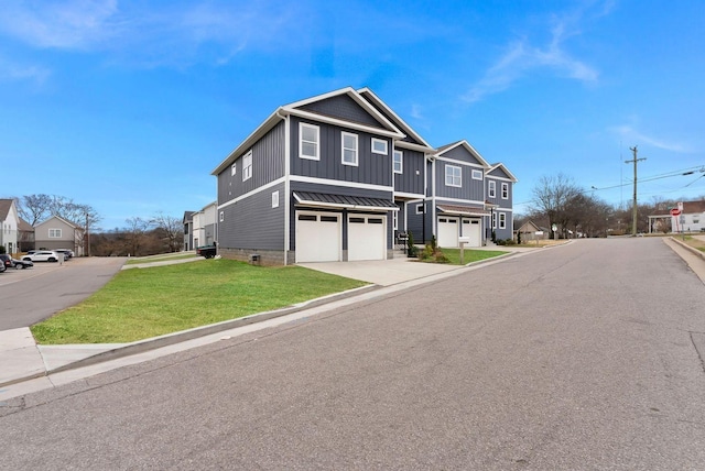 view of front of home featuring a garage, driveway, a residential view, a front lawn, and board and batten siding