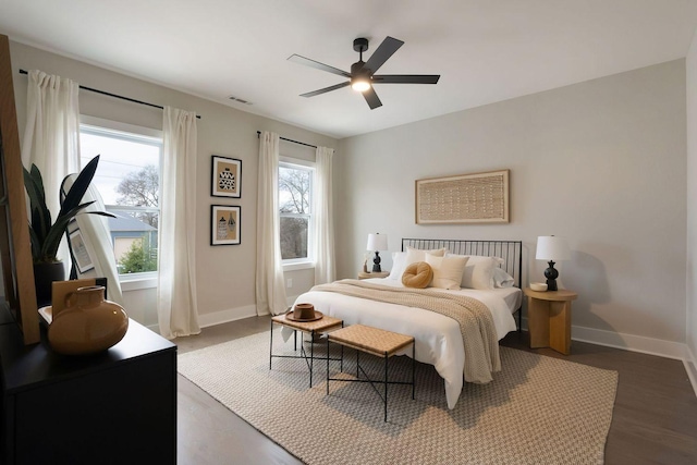 bedroom with visible vents, ceiling fan, baseboards, and wood finished floors