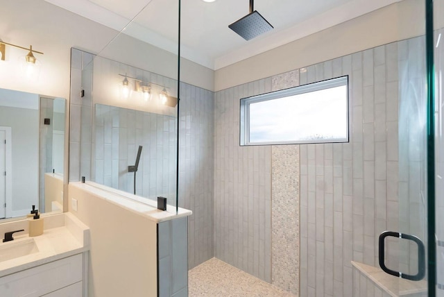 bathroom featuring a walk in shower and vanity