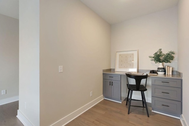 office with baseboards and wood finished floors